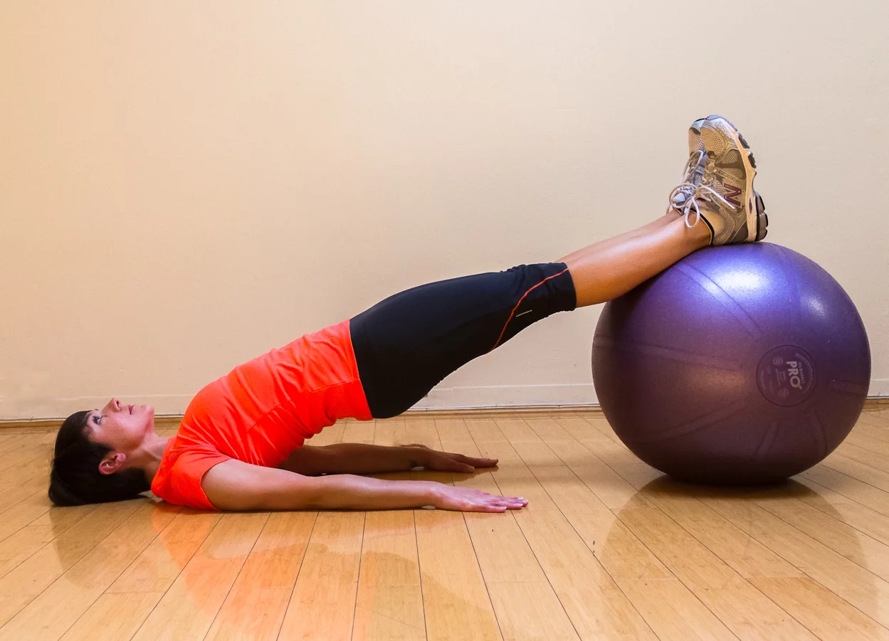 5 Pilates Ball Exercises That Will Take The Edge Off Your Back Pain